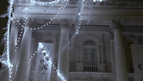 Close-up-detail-shot-of-strands-of-Christmas-lights-holiday-decorations-hung-on-the-facade-of-the-Tate-Britain-museum