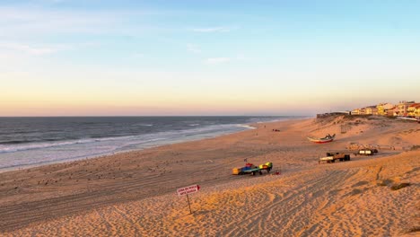 Pristine-sandy-coastline-washed-by-the-Atlantic-Ocean-during-golden-hours-in-Pedrogao-beach,-Portugal