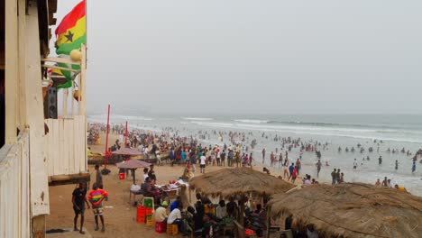 established-of-african-people-gathering-at-sunset-in-Sakumono-beach-with-ghana-flag