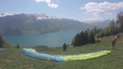 Tourists-Getting-Ready-For-Tandem-Paragliding-In-Switzerland---wide-shot