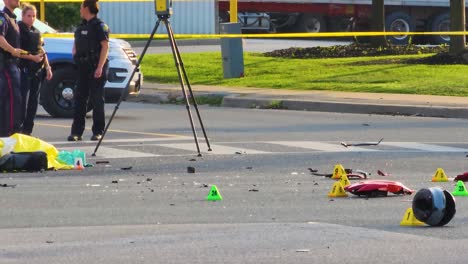 Police-Investigators,-Marked-Evidence,-And-Victim's-Corpse-At-The-Cordoned-Off-Scene-Of-Fatal-Motorcycle-Accident-In-Brampton,-Canada
