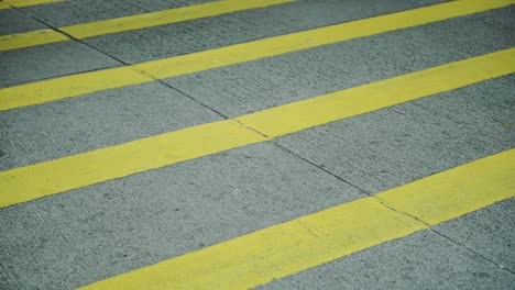Feet-Of-Pedestrians-Crossing-On-The-Pedestrian-Lane-In-Hong-Kong---Closeup-Shot