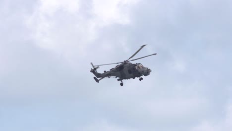 Navy-lynx-helicopter-makes-a-turn-in-slow-motion,-close-up-zoom-shot,-Bournemouth,-UK