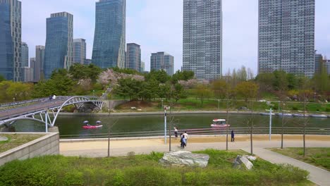 People-walking-at-a-park-nearby-high-rise-buildings