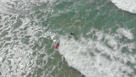 Beginner-surfer-cruising-and-falling-on-the-mild-waves-of-Santinho-Beach-in-Florianopolis-Brazil