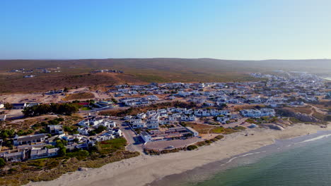 Scenic-coastal-village-of-Paternoster-with-whitewashed-houses,-Weskus,-drone-pan