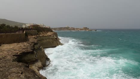 Waves-Crashing-On-Rocks-In-Marsalforn,-Gozo