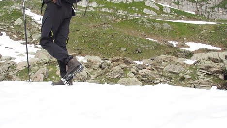 Slow-Motion-Close-Up-Legs-of-Mountaneer-Man-Walking-on-Snow-and-Climbing-on-Mountain