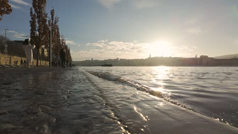 Closeup-of-flooding-Danube-River-at-"Antall-Jozsef-Quay"-during-sunset-in-Budapest,-Hungary---December-26,-2023