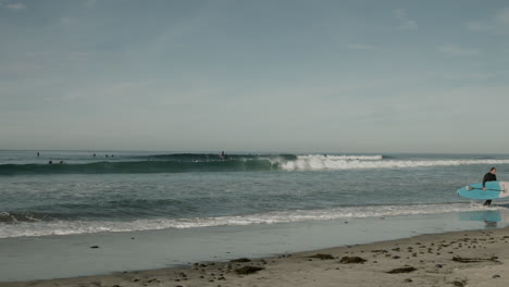A-surfer-at-a-beach-near-Cardiff,-California