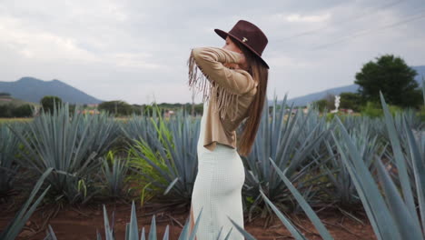Attractive-girl-walking-and-modelling-in-Agave-plantation---Tracking-shot