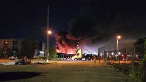 Emergency-major-industrial-fire-burning-at-night-in-Toronto,-Canada