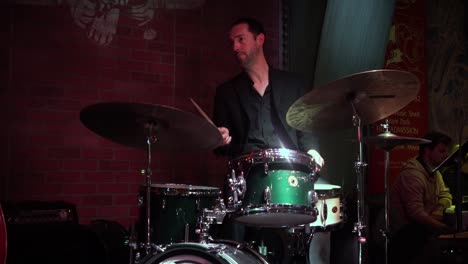 A-white-ambitious-musician-is-playing-drums-at-a-Chicago-restaurant-Andrews-jazz