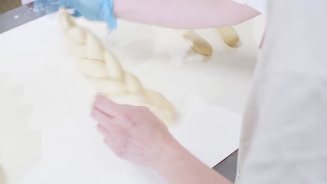 Adult-Hands-Making-Fresh-Triple-Dough-Baguette-On-Moving-Conveyor-Belt