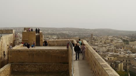People-Walking-On-The-Walls-Of-The-Citadel-Of-Victoria,-Gozo