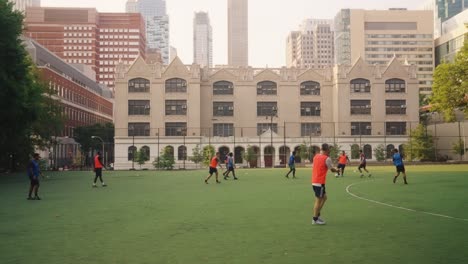 Slow-motion:-Group-of-young-teenager-playing-soccer-on-field-in-New-York-City