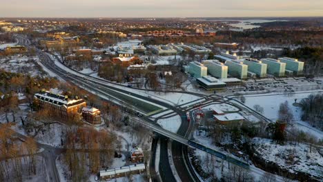Winter-sunrise-aerial-footage-approaching-Stockholm-University-located-in-Stockholm,-Sweden