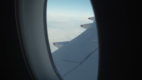 Airplane-wing-through-window.-Slow-motion,-push-in