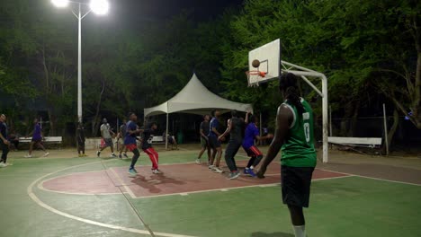 Low-angle-slow-motion-black-people-play-at-night-basketball-match
