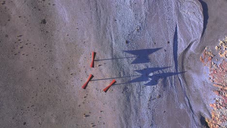 Top-Down-zoom-out-view-of-the-Miserios-a-Work-of-Art-by-Christian-Boltanski-on-beach-bahia-bustamante-with-long-shadows