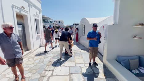 Oia-Santorini-Greece-Island-Travel-Tourist-Immersive-Walk,-Europe,-4K-|-Greek,-Aegean,-Sea,-Cliffside,-Ocean,-City,-Vacation,-Shopping,-White,-Marble,-Crowd,-Flowers,-Traveler,-People,-Alley,-Disabled