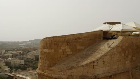 Kid-Climbs-On-A-Cannon,-Citadella-Of-Victoria-In-Gozo