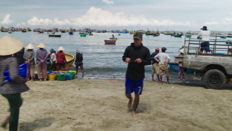 Tracking-shot-of-fishing-activity,-transport-vehicles-at-Mui-Ne-beach