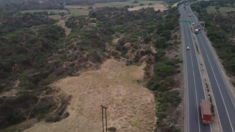 Aerial-view-of-Srinagar-Delhi-Chennai-Kanyakumari-national-highway-cutting-through-the-iconic-gully-erosions-in-the-badlands-of-Chambal-ravines-near-Rajasthan-Madhya-Pradesh-border,-India