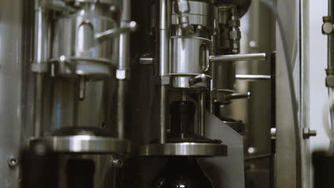 Filling-empty-wine-bottles-on-an-industrial-conveyor-line