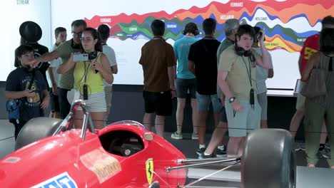 Visitors-take-photos-at-the-Ferrari-F1-F187-and-88C-exhibition-at-IFEMA-Madrid-in-Spain