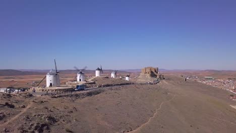 Drone-Shot,-truck-right-slow-movement-in-front-of-an-old-windmill-in-Consuegra