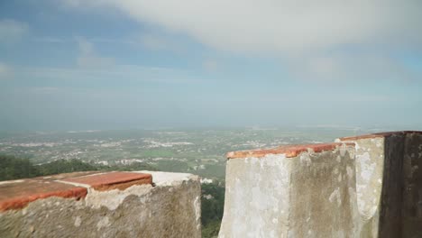 Establishing-shot,-Moving-forward-revealing-the-Scenic-view-of-Sintra,-Portugal,-cloudy-blue-sky-in-the-background