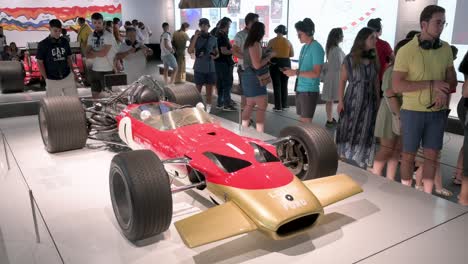 Visitors-look-and-take-photos-of-the-Lotus-type-49-racing-car-seen-displayed-during-the-world's-first-official-Formula-1-exhibition-at-IFEMA-Madrid-in-Spain