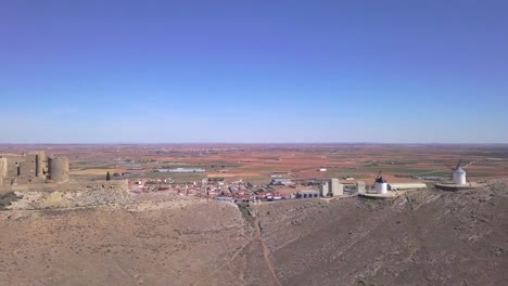 Drone-Shot,-truck-right-with-side-view-of-the-castle-and-windmills-from-the-Cervantes'-Don-Quijotte