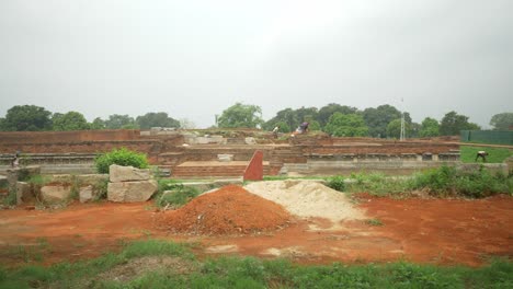 Wide-shot-of-the-construction-laborers-working-on-the-excavation-and-restoration-work-on-the-ruins-of-Nalanda-Mahavihara-an-ancient-Buddhist-monastic-university-that-was-demolished-by-Mughal-Invaders