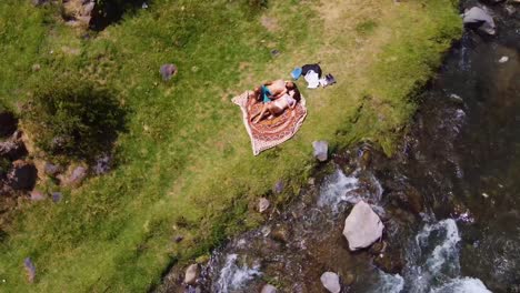 Romantic-Couple-Laying-Down-Together-Enjoying-Superb-River-Landscape,-Obrajillo