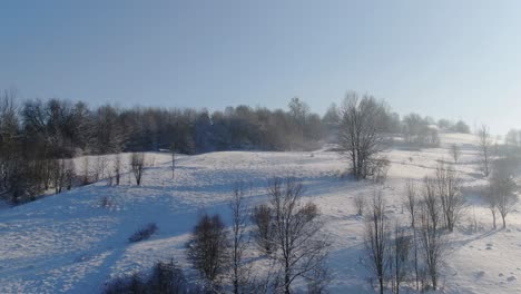 Revealing-snow-covered-hillside,-serene-winter-landscape