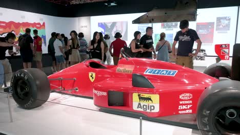 Visitors-look-and-take-photos-of-the-Ferrari-F1-F187-and-88C-exhibition-at-IFEMA-Madrid-in-Spain