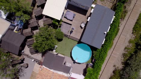 Top-down-aerial-view-of-camping-home-with-swimming-pool-in-southern-France