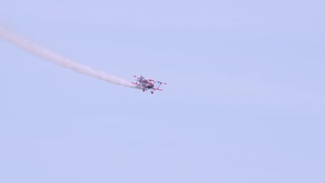 Red-muscle-biplane-flying-in-blue-sky-in-slow-motion
