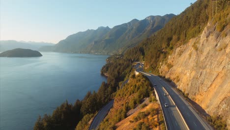 Golden-light-on-side-of-mountain-and-aerial-view-of-Trans-Canada-Highway