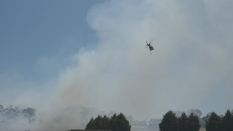 Fire-rescue-helicopter-racing-to-put-out-grass-fire-flying-into-thick-smoke