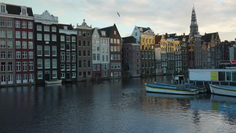 Iconic-Amsterdam-canal-scene-with-historic-houses-and-boats-in-early-morning
