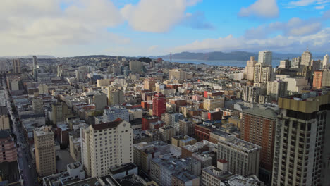Panoramic-aerial-of-San-Francisco-Union-Square-neighbourhood-with-famous-Golden-Gate-Bridge-in-the-background,-California,-USA