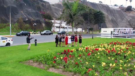 Girls-in-dresses-waving-at-the-camera-during-a-photoshoot-at-a-field-of-flowers-for-a-birthday-party
