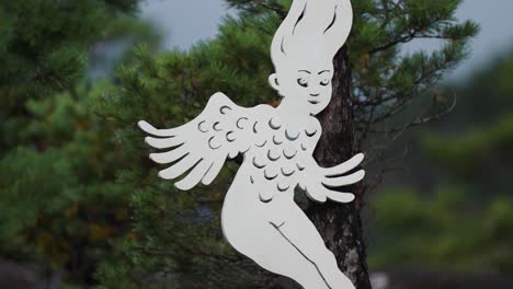 A-fairy-sculpture-on-a-pine-tree-in-the-open-air-gallery-on-the-shores-of-the-Hardanger-fjord