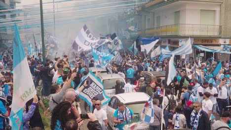 Slow-motion-shot-of-many-napoli-fans-celebrating-triumph-after-win-in-soccer-league-on-road---waving-flags-with-dangerous-pyrotechnic