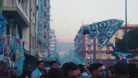 Close-up-of-napoli-fans-waving-italian-flag-on-street-of-Naples-City-after-wind-of-serie-A