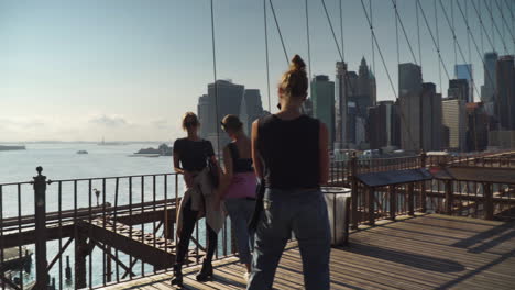 Tourists-taking-pictures-for-social-media-in-Brooklyn-Bridge-over-the-East-River---Pan-shot