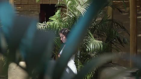 Nice-Shot-Through-Green-Leaves-Of-Beautiful-Woman-With-White-Dress-,-Lima,-Peru